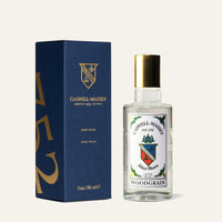 A bottle of Caswell Massey Woodgrain Sandalwood Aftershave with a gold cap stands beside its blue and gold box, featuring a vintage-style label and crest. The box displays the number "752" vertically, evoking classic barbershop elegance.