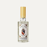 A clear glass bottle of Caswell Massey Woodgrain Sandalwood Cologne features a gold cap and decorative label—an elegant presentation for this classic sandalwood scent from Caswell Massey.