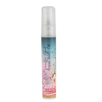 A small spray bottle labeled “Barefoot Venus The Vanilla Effect Argan Body Oil” (mini size) by Barefoot Venus, with a colorful floral design, provides luxurious hydration with nourishing argan oil, shown against a plain white background.