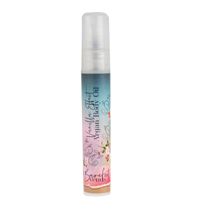 A small spray bottle labeled “Barefoot Venus The Vanilla Effect Argan Body Oil” (mini size) by Barefoot Venus, with a colorful floral design, provides luxurious hydration with nourishing argan oil, shown against a plain white background.