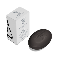 A black oval Caswell-Massey Oaire Bar Soap rests next to its white rectangular box, featuring black lettering and the number 752 on the side.
