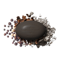 A dark Caswell-Massey Oaire Bar Soap, embossed with "America's Original Caswell-Massey Since 1752," rests on scattered peppercorns and spices, adding natural elegance to your daily ritual.