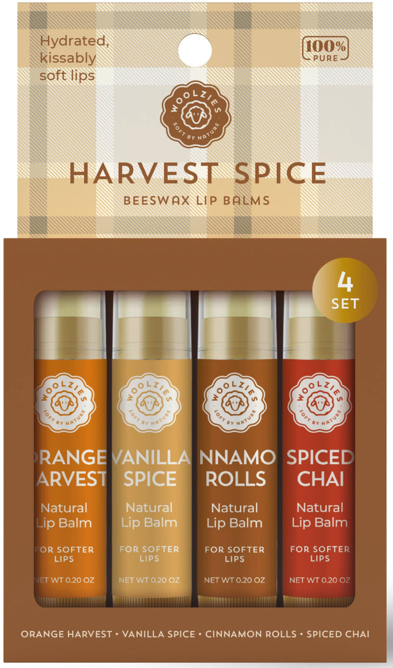 Packaging for Woolzies Harvest Spice Lip Balm Set Of 4, a four-set including orange harvest, vanilla spice, cinnamon rolls, and spiced chai flavors, displayed in an orange-themed box with circular logos