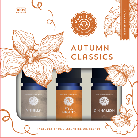 The Woolzies Autumn Classics Collection by Woolzies includes three 10ml bottles of Vanilla, Fall Nights, and Cinnamon essential oils in a box with orange floral designs labeled “100% pure.”.