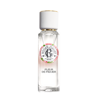 A transparent bottle of Roger & Gallet Fig Blossom fragrant water with a white cap and a pink and green label, isolated on a white background.
