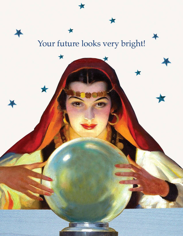 A woman in a red headscarf and gold jewelry gazes into a glowing crystal ball amid blue stars. Above, “Your future looks very bright!”—an eco-friendly greeting card by P. Flynn Design / Phun House, Portland OR.