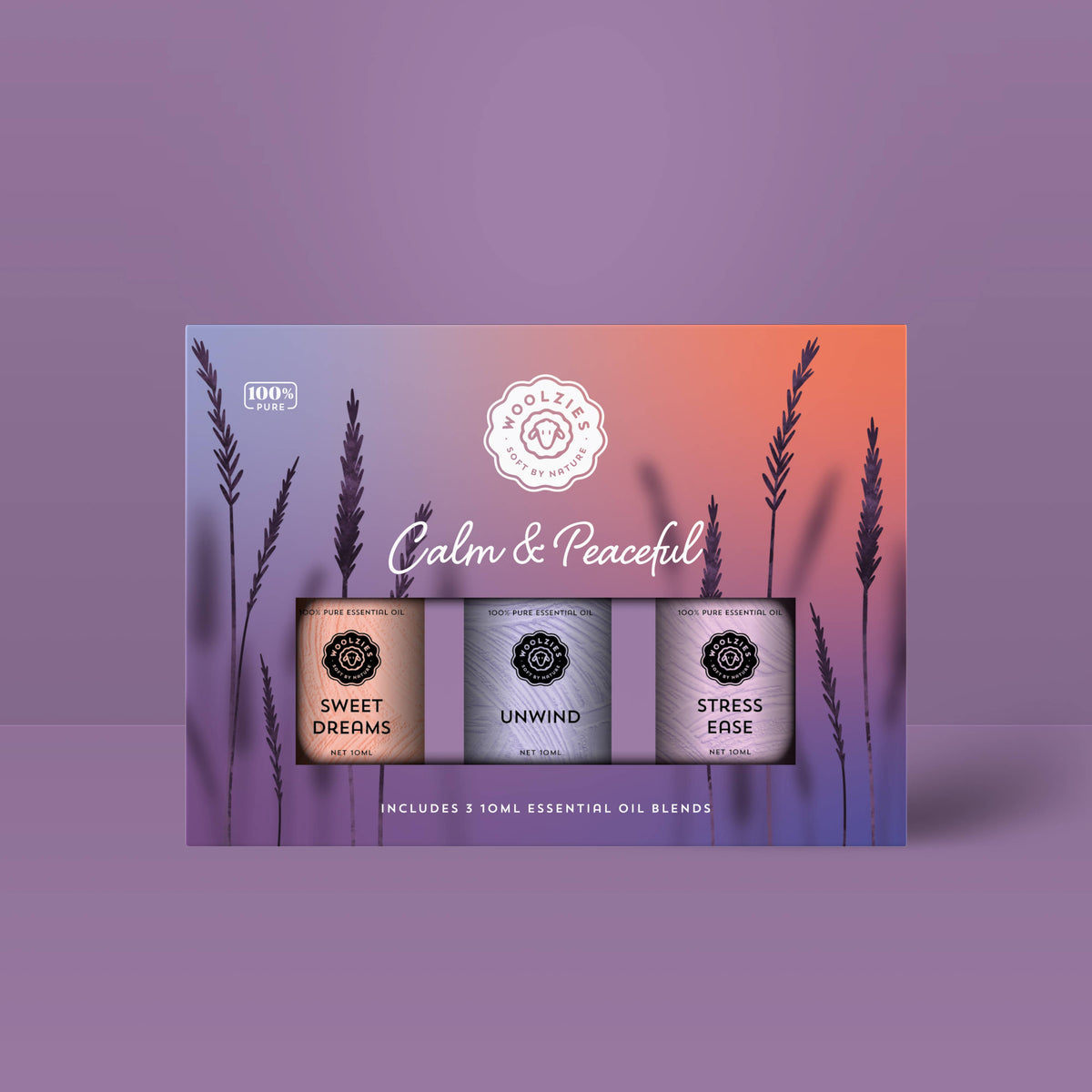 The Woolzies Calm & Peaceful Collection features three essential oils—Sweet Dreams, Unwind, and Stress Ease—shown against a purple and peach gradient background with lavender silhouettes for restful sleep and a calm mind.