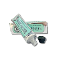 The "Wag & Bright Supply Co. - Puppy Polish Toothpaste - Filet Mignon (Beef)" tube, adorned with a mint green and white design, provides an oral care solution for dogs with a delicious beef flavor. The tube is partially squeezed beside its black cap, and the product box is visible in the background. It's formulated with natural ingredients to support your dog's health.