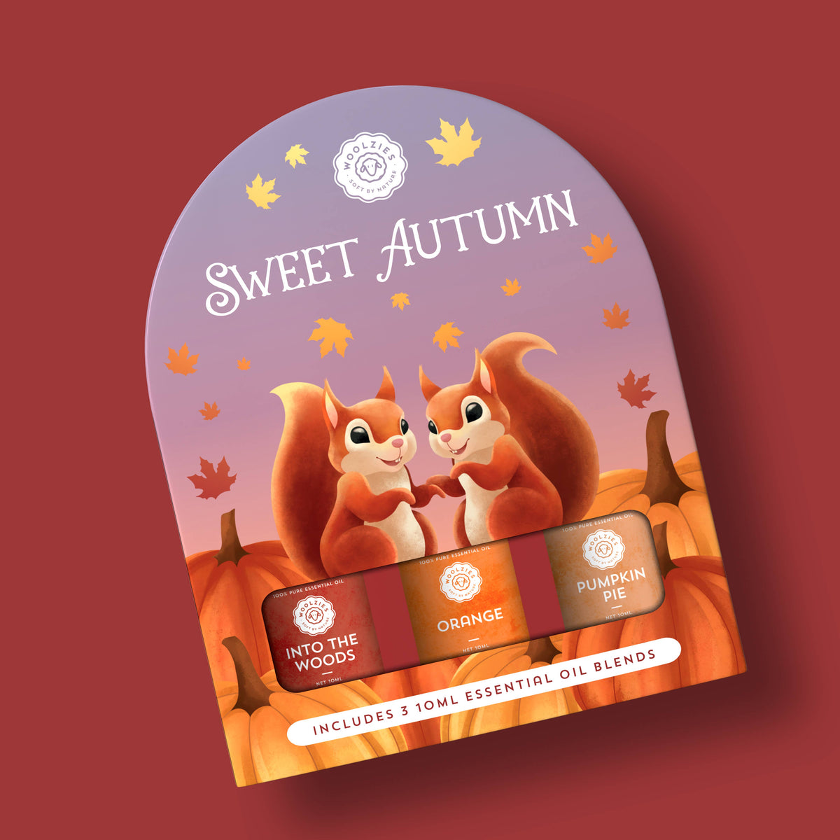 The Woolzies Sweet Autumn Collection package by Woolzies features two smiling squirrels among pumpkins and leaves, and contains three essential oils: Into the Woods, Orange, and Pumpkin Pie.