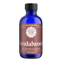 A blue glass bottle of Woolzies Sandalwood Essential Oil (10ml) with a black cap and brown label, known for its soothing aroma and skin benefits. Brand: Woolzies.