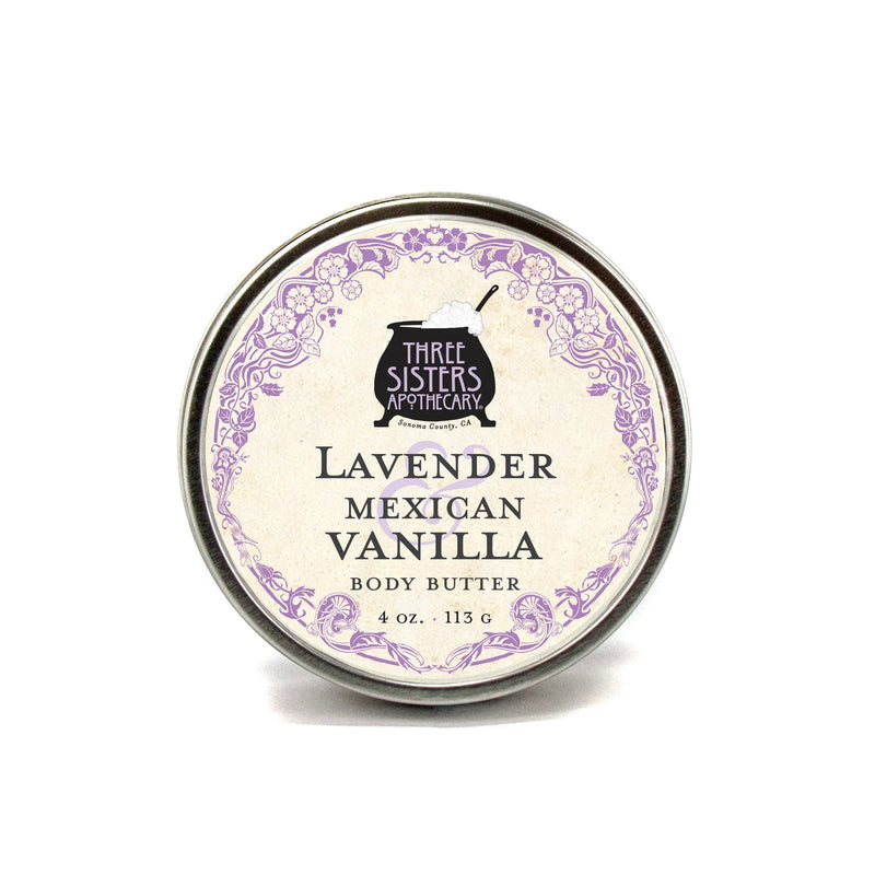 A round tin of Three Sisters Apothecary Lavender & Mexican Vanilla Body Butter, 4 oz (113 g), features a decorative purple border and vintage font—ideal for natural skin hydration.