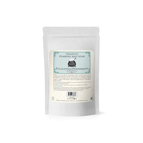 A white, resealable 20oz pouch labeled "Three Sisters Apothecary Therapeutic Foaming Eucalyptus & Peppermint" with Epsom salts, product details, and instructions on the front.