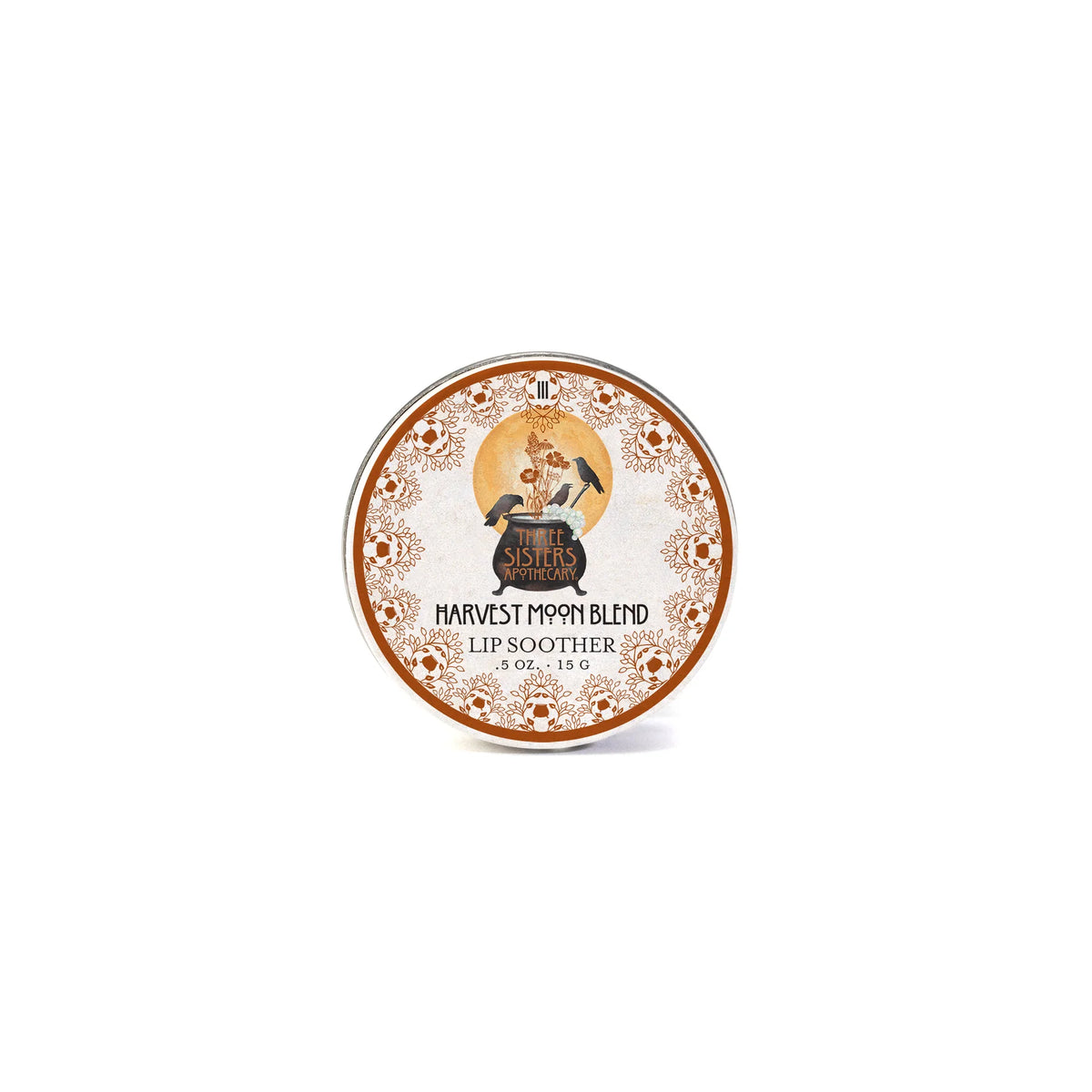 A round tin of Three Sisters Apothecary Harvest Moon Lip Soother, featuring a vintage illustration of a woman and orange floral borders, labeled with the brand Three Sisters Apothecary.