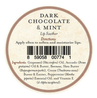 A round lip balm label for Three Sisters Apothecary Dark Chocolate & Mint Lip Soother shows directions, a barcode at the center, and natural ingredients such as oils, beeswax, shea butter, cocoa, peppermint, and vitamin E to moisturize lips.