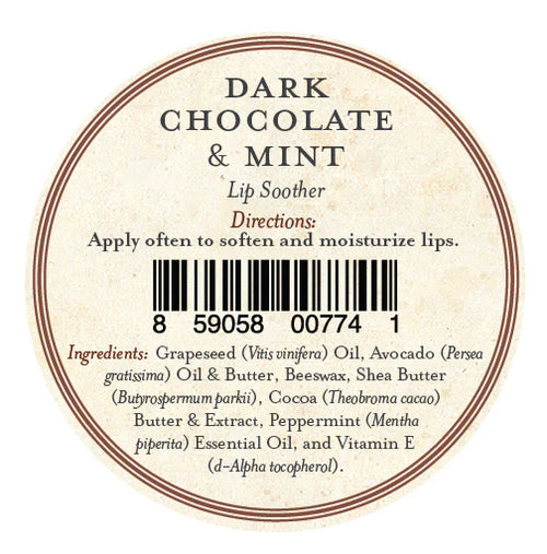 A round lip balm label for Three Sisters Apothecary Dark Chocolate & Mint Lip Soother shows directions, a barcode at the center, and natural ingredients such as oils, beeswax, shea butter, cocoa, peppermint, and vitamin E to moisturize lips.