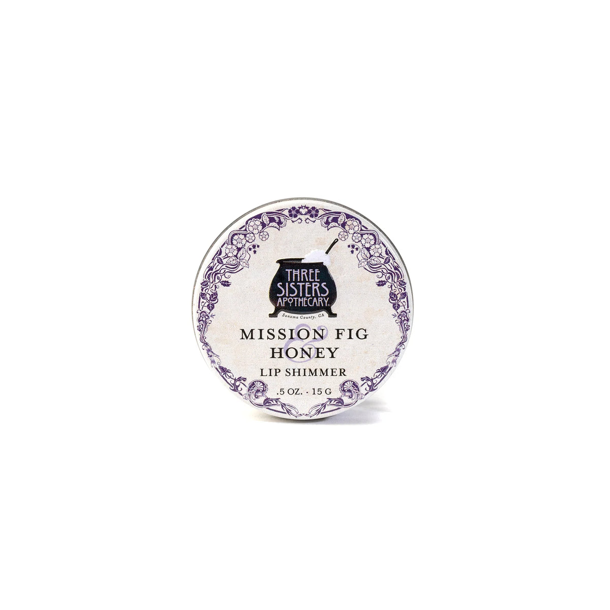 Three Sisters Apothecary California Mission Fig & Honey Lip Shimmer, 0.5 oz tin, features natural beeswax and a decorative purple border on white—ideal for hydrating lips.