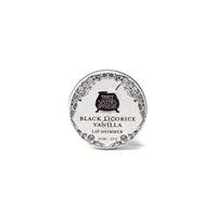 A round tin labeled "Three Sisters Aphothecary Black Licorice & Vanilla Lip Soother, 0.5 oz, 15 g" features floral designs on white. This hydrating balm is made with natural beeswax for soothing care.