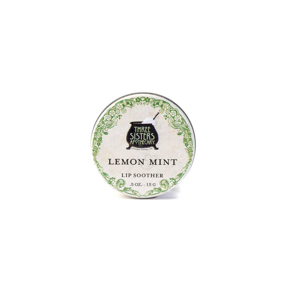 A round tin of Three Sisters Apothecary Lemon & Peppermint Lip Soother, 0.5 oz, with a green decorative border and text on the lid, highlights this natural, hydrating lip balm by Three Sisters Apothecary against a white background.
