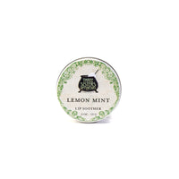 A round tin of Three Sisters Apothecary Lemon & Peppermint Lip Soother, 0.5 oz, with a green decorative border and text on the lid, highlights this natural, hydrating lip balm by Three Sisters Apothecary against a white background.