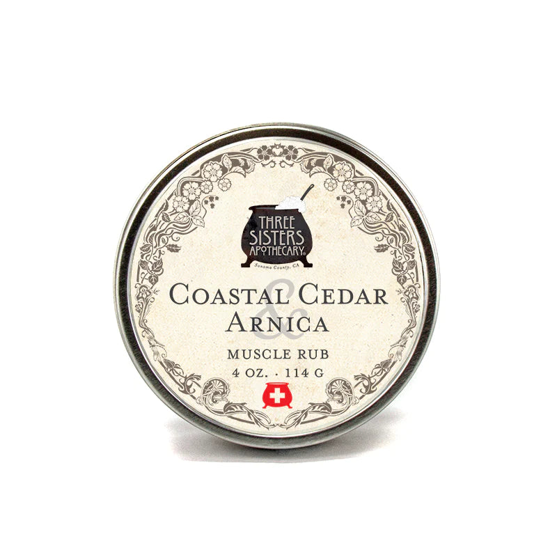 Round tin container of Three Sisters Apothecary Coastal Cedar & Arnica Muscle Rub with Menthol Camphor, displaying a vintage label design, isolated on a white background.