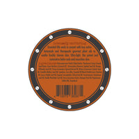 A circular product label with an orange and black design features the text “Intensely nurturing” at the top. The label for Three Sisters Apothecary Shave Balm - Bay Rum lists essential oils and botanical ingredients like therapeutic plant oils, shea butter, tamanu oil, and coconut oil. A barcode is present at the bottom.