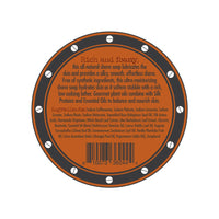 A circular label for the Three Sisters Apothecary Shave Soap - Bay Rum infused with Bay Rum essential oil. The orange label has a brown border adorned with small white circles. It describes the product as rich and foamy, listing ingredients such as nourishing natural oils and extracts. A barcode is positioned at the bottom.