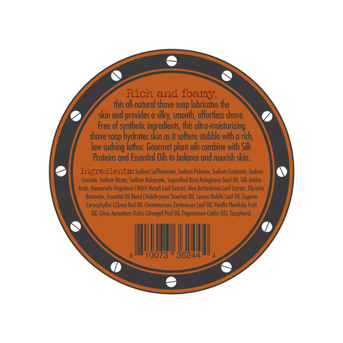 A circular label for the Three Sisters Apothecary Shave Soap - Bay Rum infused with Bay Rum essential oil. The orange label has a brown border adorned with small white circles. It describes the product as rich and foamy, listing ingredients such as nourishing natural oils and extracts. A barcode is positioned at the bottom.