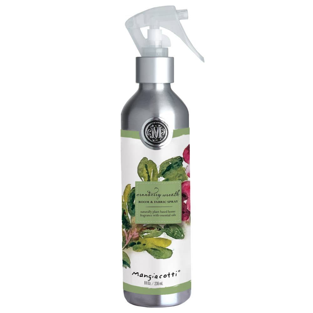 A silver spray bottle labeled "Mangiacotti Cranberry Wreath Room & Fabric Spray" features a festive design—ideal as a holiday fragrance or Christmas room spray.