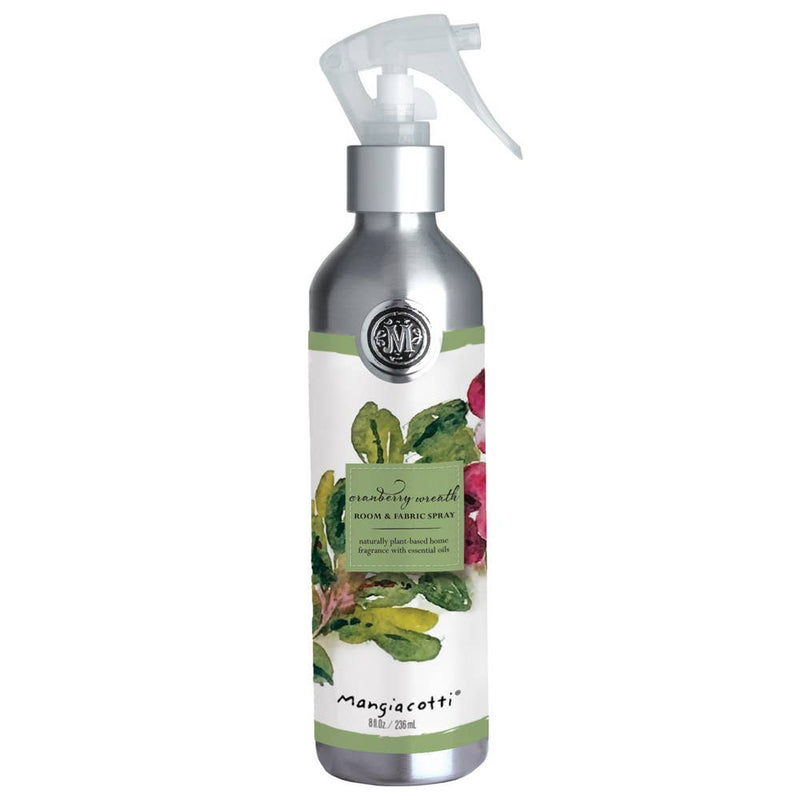 A silver spray bottle labeled "Mangiacotti Cranberry Wreath Room & Fabric Spray" features a festive design—ideal as a holiday fragrance or Christmas room spray.