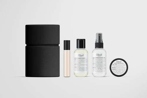 L'floof Travel-Size Grooming Set by L'floof features five minimalist, eco-friendly products in black and white: a cylindrical container, roll-on bottle, two pump or spray bottles, and a round jar—all with labeled text on a white background.