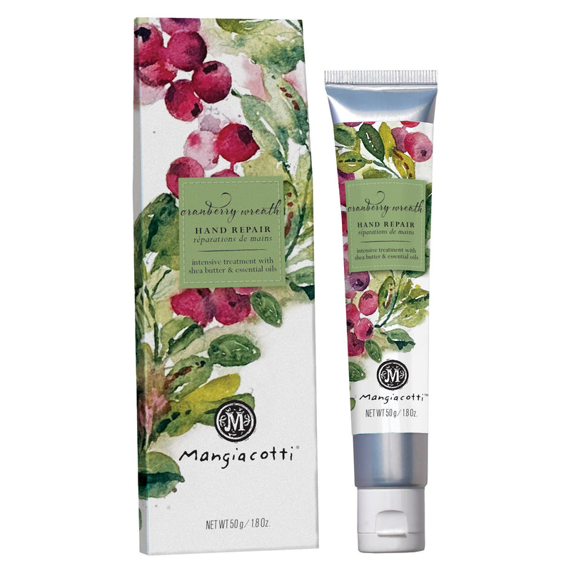 A tube and box of Mangiacotti Cranberry Wreath Hand Repair cream, featuring green and red watercolor cranberries and leaves. This 50g (1.8 oz) Mangiacotti cream provides rich skin nourishment with every use.