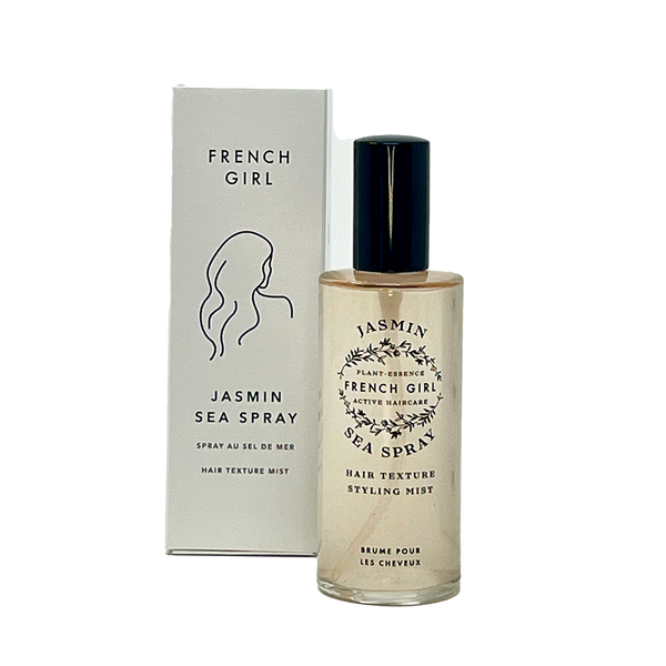 A bottle of FRENCH GIRL Organic Sea Salt Hair Mist & Texturizing Spray – Jasmine stands before its white box packaging with minimalist design—ideal for creating beachy waves using this clean, organic hair mist by FRENCH GIRL.