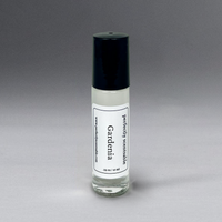 A small bottle of "Perfectly Scentsable Gardenia Perfume Oil - Rollerball" with a 0.33 oz (10 ml) capacity. The bottle features a black cap and a white label adorned with text, promising a long-lasting aroma. Its backdrop is a gray gradient, enhancing the allure of its floral scent.