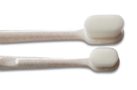 Two Wag & Bright Supply Co. Puppy Polisher Mini Eco Toothbrushes (Small), designed with sustainable bioplastic, showcase smooth white bristles and lightly speckled handles. Their minimalist aesthetic harmonizes with the eco-friendly materials against a white background.