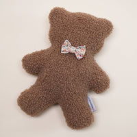The MODERNBEAST Modernbeast Lavender Teddy Bear with Bowties is a soft, textured plush toy featuring a floral bowtie and white tag—perfect as a soothing bedtime companion for peaceful nights.
