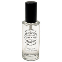 The FRENCH GIRL Organic Floral Face Mist Hydrating Toner - French Rose is a clear glass spray bottle with a black cap and floral design, perfect for organic skincare lovers seeking a refreshing, rose-infused hydrating mist.