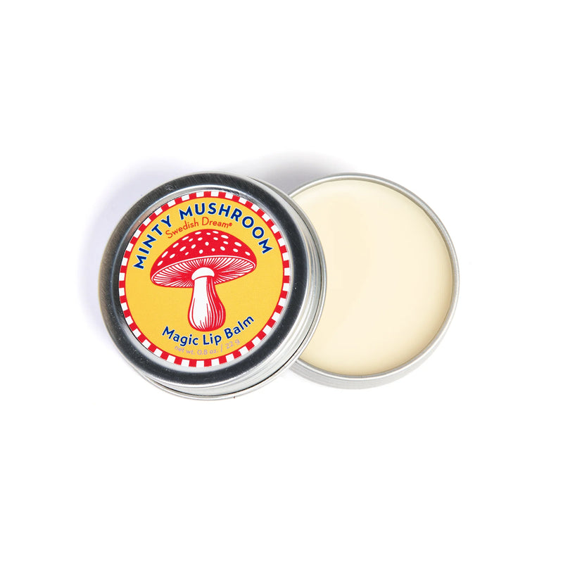 A round, open tin of Kala Swedish Dream Minty Mushroom Lip Balm shows its creamy balm inside. The yellow label displays a red and white mushroom illustration, and the balm is infused with organic mushroom extracts for natural lip care.