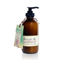 Amber pump bottle labeled "Barefoot Venus Pink Pepper Body Cream" by Barefoot Venus, enriched with shea butter and macadamia nut oil. A handwritten tag around the neck reads, "There is no time to be bored in a world as beautiful as this.