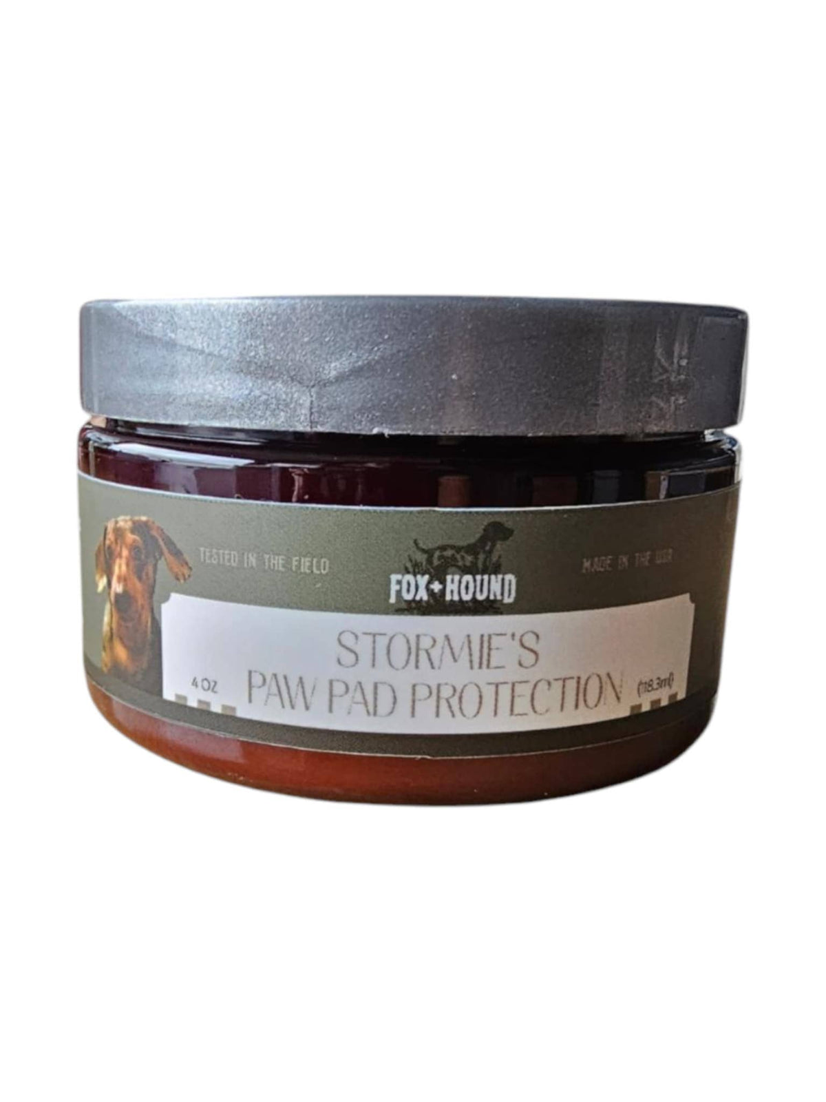 Fox + Hound Stormies Paw Protection – All Season is a 4 oz round jar with a silver lid, featuring a dog image and label text, delivering premium paw balm for effective dog paw pad care.