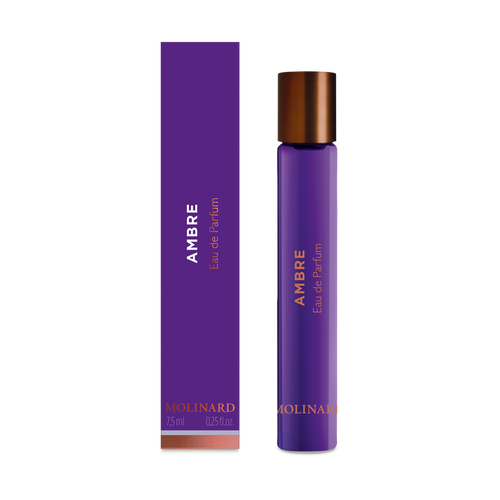 The Molinard Ambre Eau de Parfum Roll-On features a purple box and matching cylindrical bottle with copper accents and metallic cap, offering 7.5 ml (0.25 fl oz) of fragrance by Molinard.