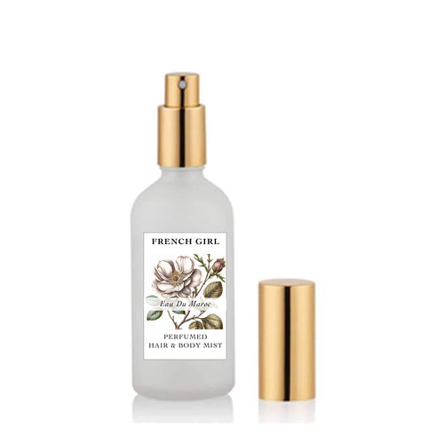 The FRENCH GIRL Perfumed Hair & Body Mist is an alcohol-free, vegan spray in frosted glass with a gold pump and cap, featuring white floral botanicals. Available in 3 scents as part of the Mediterranean Perfume Collection.