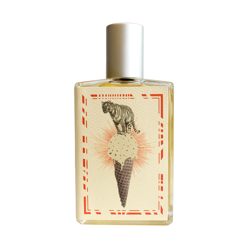 Introducing the Imaginary Authors A Whiff of Wafflecone - Large Size perfume, adorned with a silver cap. The label boasts an illustration of a tiger majestically perched atop an ice cream cone with a waffle pattern. The cone holds a delightful scoop of vanilla ice cream sprinkled with chocolate bits. This vintage-style design is framed by red decorative borders, evoking a nostalgic sense of sweet memories.