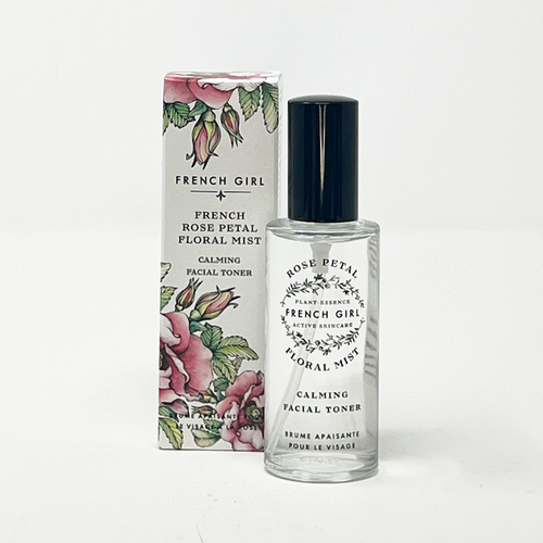 A clear glass bottle of FRENCH GIRL Organic Floral Face Mist Hydrating Toner - French Rose stands before its box, both featuring black text and botanical designs.