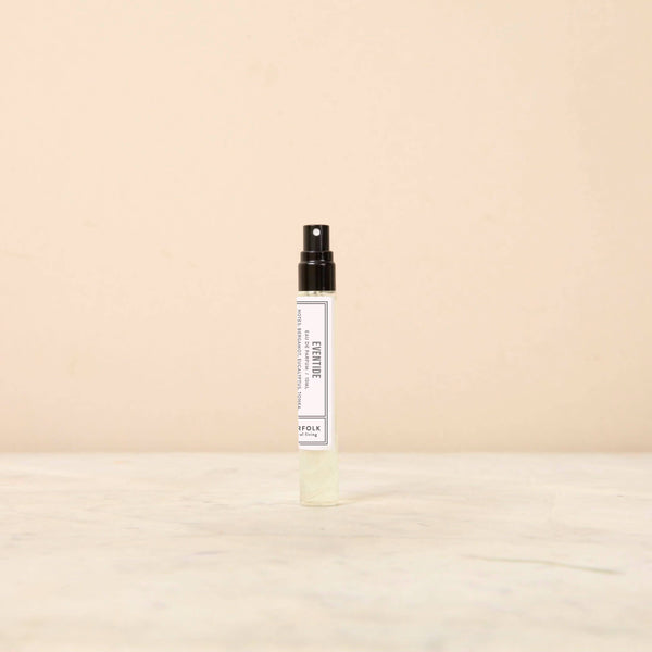 A 10ml bottle of Norfolk Natural Living Eventide Parfum, celebrated for its romantic sandalwood notes, stands upright on a light textured surface with a plain beige background.