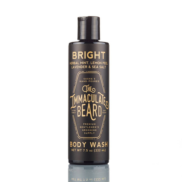 The Immaculate Beard BRIGHT Body Wash comes in a 7.5 oz black bottle with gold lettering, offering a masculine scent and ingredients like herbal mint, lemon peel, lavender, and sea salt.