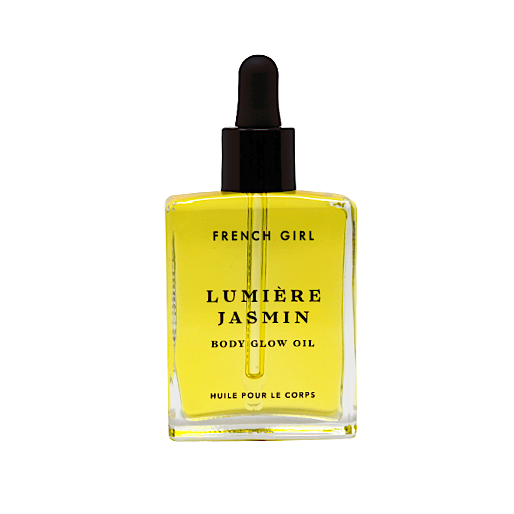 A clear glass dropper bottle of FRENCH GIRL Organic Hydrating Jasmine Body Oil (2 oz), filled with yellow oil, features black text on the front and a black dropper cap.