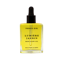 A clear glass dropper bottle of FRENCH GIRL Organic Hydrating Jasmine Body Oil (2 oz), filled with yellow oil, features black text on the front and a black dropper cap.