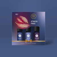 The Woolzies Stress Free Holiday Collection features three essential oil blends—Sleep, Relax, and Unwind—decorated with feather art on a dark blue box, designed to promote calm and relaxation with soothing lavender from Woolzies.