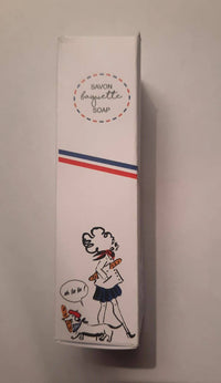A box of Senteurs De France "Baguette" Soap features a cartoon woman with a baguette and dog saying "oh la la," plus a French flag stripe—a charming Parisian-themed keepsake by Senteurs De France.