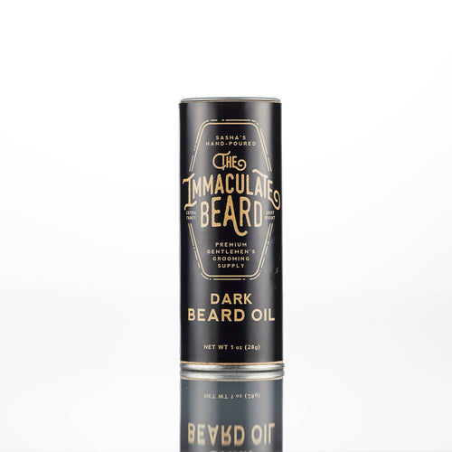 A black cylindrical container of "The Immaculate Beard DARK Beard Balm," a premium handmade grooming supply by The Immaculate Beard, stands upright on a plain white background.